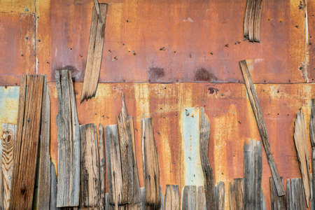 rusty metal and weathered wooden shingles - old building wall background