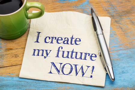 I create my future now - positive affirmation - handwriting on  napkin with a cup of coffeeの写真素材