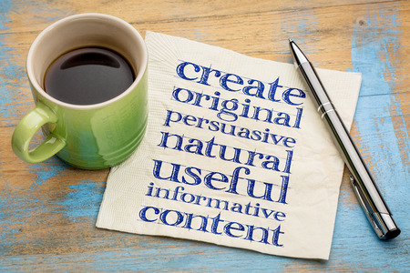 write original, persuasive, natural, useful, informative content - creating content advice - handwriting on napkin with cup of coffeeの写真素材