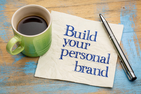 Build your personal brand advice - handwriting on a napkin with a cup of espresso coffeeの写真素材