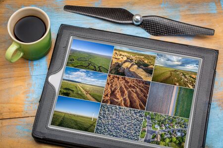 Reviewing and editing aerial pictures on a digital tablet with a cup of coffee - natural, urban and...