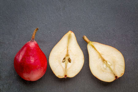 red pears on a gray slate stone backgroundの写真素材