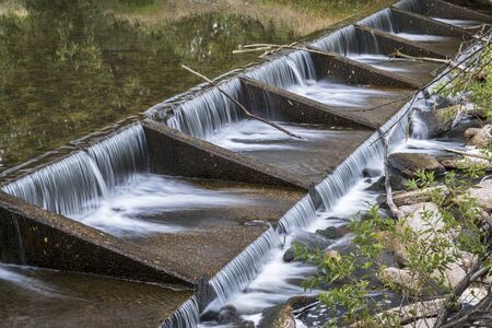 one of numerous diversion water diversion dams on the Poudre RIver in Fort Collins, Coloradoの写真素材