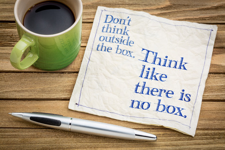 Don't think outside the box. Think like there is no box.- handwriting on a napkin with a cup of espresso coffeeの写真素材