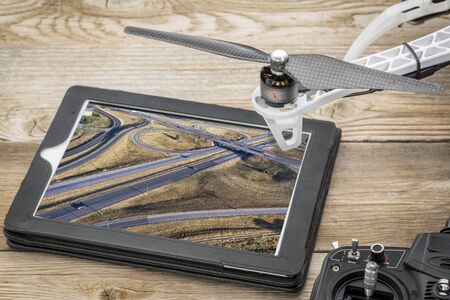 aerial landscape photography concept - reviewing aerial pictures of a freeway in Colorado on a digital tablet with a drone rotor, screen picture copyright by the photographerの写真素材