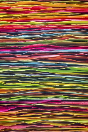 stack of colorful sticky notes - side view of rough paper edges