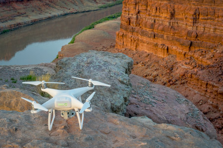 MOAB, UT, USA - MAY 7, 2017:  DJI Phantom 4 pro drone is ready to take off in the canyon of Colorado River for sunrise photography.のeditorial素材