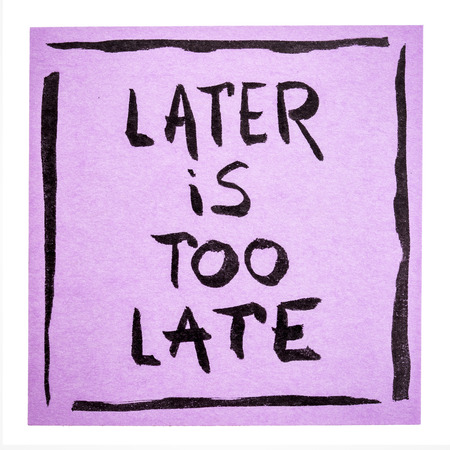 Later is too late - motivational handwriting on an isolated sticky noteの写真素材