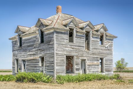 abandoned old house in rural Nebraska in the middle of a fieldの写真素材