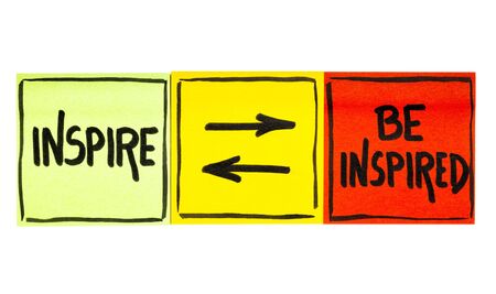 inspire and be inspired concept - handwriting in black ink on an isolated sticky note
