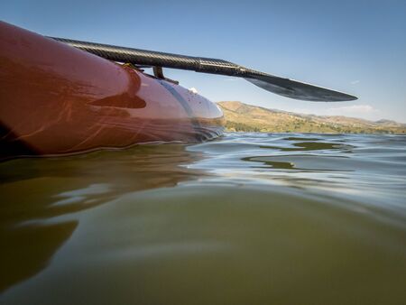 Stand up paddleboard with a paddle on a lake, partially underwater shotの写真素材