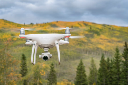 Kenosha Pass, CO, USA - September 14, 2017:  Radio controlled DJI Phantom 4 Pro quadcopter drone is flying with a camera in Rocky Mountains with fall colors.のeditorial素材