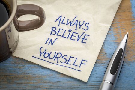 Always believe in yourself - handwriting on an napkin with a cup of coffee