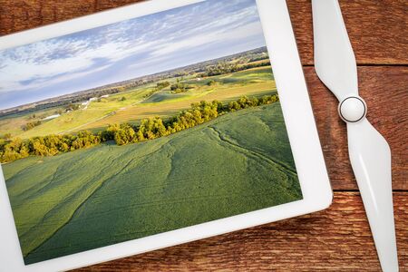 green soybean fields  in a valley of the Missouri River, near Glasgow, MO, reviewing aerial image on...