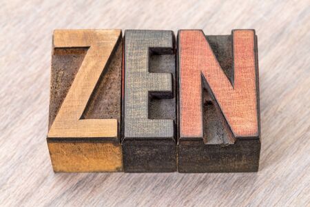 zen - word abstract in vintage wooden letterpress printing blocks stained by color inksの写真素材