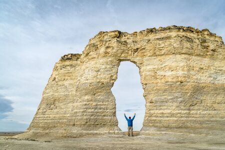 arch in Monument Rocks  (Chalk Pyramids) in western Kansas with a human figure added for a scaleの写真素材