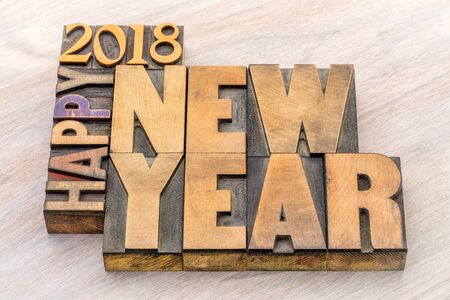Happy New Year 2018 greeting card - word abstract t in vintage letterpress wood type blocks on a grained wooden backgroundの写真素材