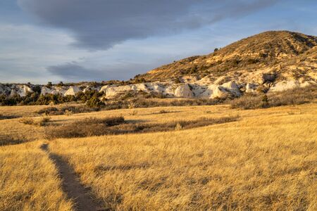 SUnset light over soapstone cliffs in  Red Mountain Open Space in northern Colorado as seen from Salt Lick Trailの写真素材
