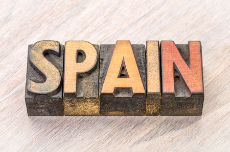 Spain word in vintage letterpress wood type against grained woodの写真素材