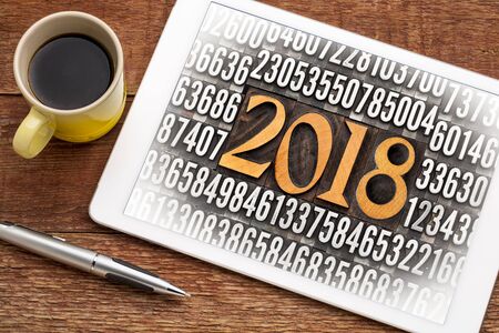 2018 number in vintage wood letterpress priniting blocks surrounded by random metal numbers on a...