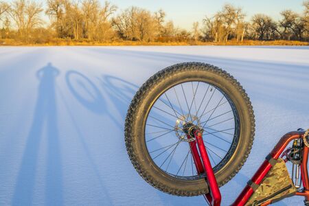 fat bike and shadows on a frozen lake in northern Coloradoの写真素材