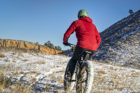 male cyclist riding a fat bike in winter Colorado foothills landscape - Lory State Parkの写真素材