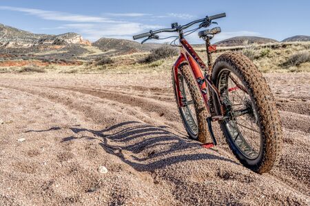 a dirty fat bike on a trail with deep, loose gravel - Big Hole Wash Trail in Red Mountain Open Space north of Fort Collins, Coloradoの写真素材