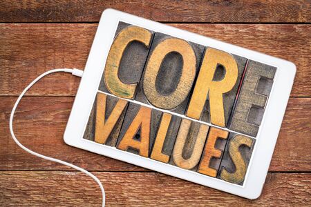 core values  banner  -  word abstract in vintage letterpress wood type blocks on a digital tablet against rustic woodの写真素材