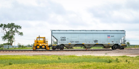 Ovid, CO, USA - May 28, 2018: Union Pacific covered hopper grain railcar with a mobile car mover (Trackmoblie 95TM) in rural eastern Colorado.のeditorial素材