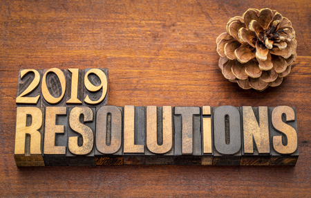 2019 resolutions word abstract in vintage letterpress wood type again st rustic wooden board with a...