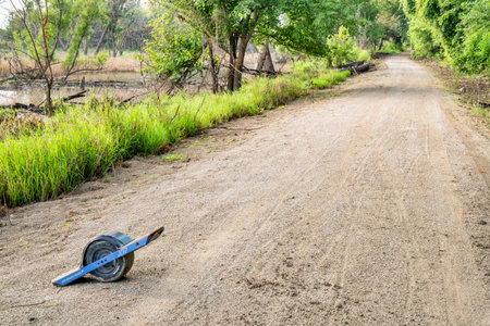 Brownville, NE, USA - July 30, 2018:  Oneweel electric skateboard on Steamboat Trail converted from abandoned railroad running along Missouri River.のeditorial素材