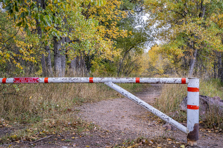 trail and fire road with a gate, fall colors scenery in Colorado