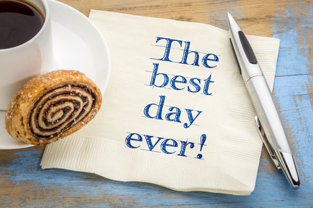 The best day ever! Positive handwriting on a napkin with a cup of coffeeの写真素材