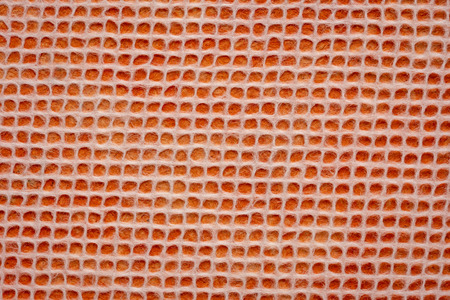 white Thai mulberry lace paper with a grid pattern against orange backgroundの写真素材