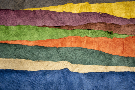 abstract landscape created with sheets of textured colorful handmade paperの写真素材