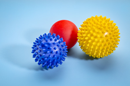 self massage and reflexology therapy concept - a set of small rubber ball  against blue backgroundの写真素材