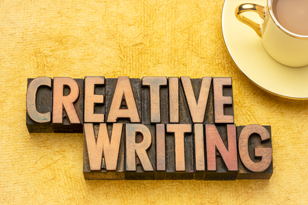 creative writing word abstract in vintage letterpress wood type with a cup of coffeeの写真素材