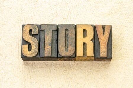 story word abstract in vintage letterpress wood type against textured handmade paperの写真素材