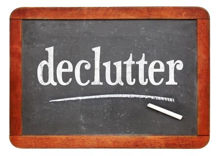 Declutter concept - White chalk text on a vintage slate blackboardの写真素材
