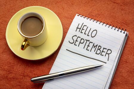 Hello September  - handwriting in a notebook with a cup of coffeeの写真素材