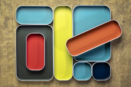 top view of colorful drawer organizer bins against textured bark paper