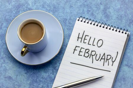 Hello Februrary, - handwriting in a notebook with a cup of coffeeの写真素材