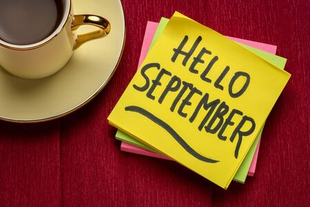 Hello September - handwriting on a sticky note with a cup of coffee