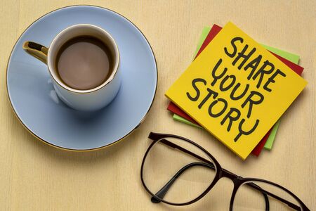 share your story - handwriting on a note with a cup of coffee, storytelling, sharing and networking conceptの写真素材