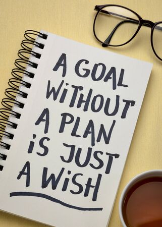 a goal without a plan is just a wish - motivational handwriting in a spiral notebook with a cup of...