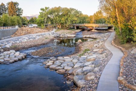 Poudre River and newly constructed whitewater park in downtown of Fort Collins, Colorado, fall scenery with a low water flowの写真素材