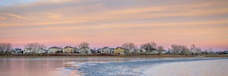 freezing lake after sunset with houses at waterfront - Boyd Lake in northern Colorado, panoramic...