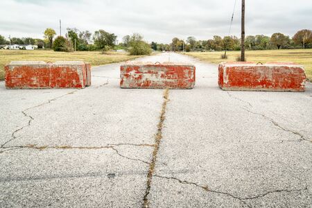 Heavy concrete roadblocks blocking highway or street. Obstacle, dead end  or obstruction to progress concept.の写真素材