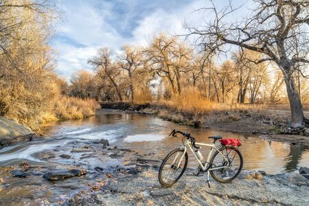 touring bike and a river in fall scenery - Big Thompson River Trail in Loveland, northern Coloradoの写真素材