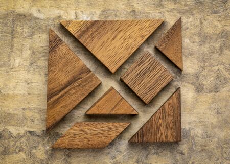 seven tangram wooden pieces, a traditional Chinese puzzle game, texture bark paper background